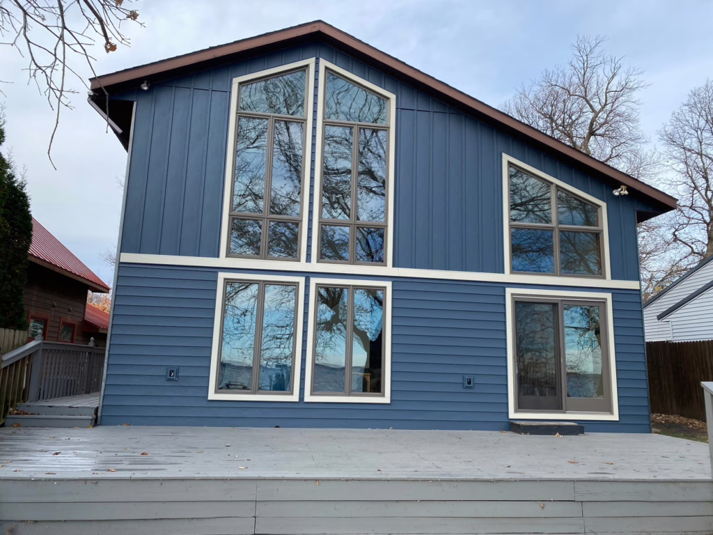 Exterior of Home With Blue Siding and Large Windows